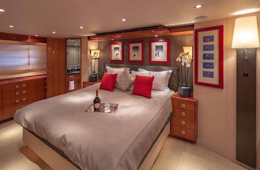 a bed with pillows on it aboard ASTRAPE Yacht for Charter