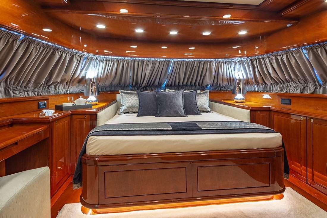 a bed with a black and white bed spread aboard DIVINE Yacht for Charter
