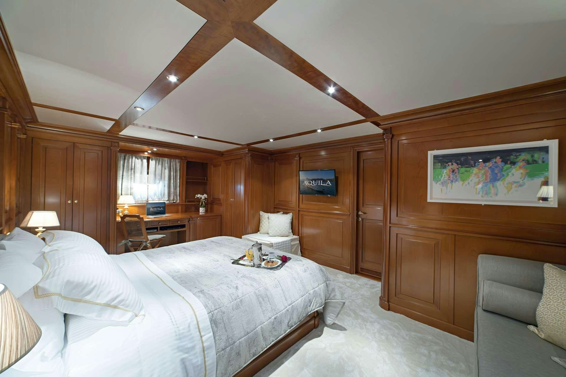 a bedroom with a large bed aboard AQUILA Yacht for Charter
