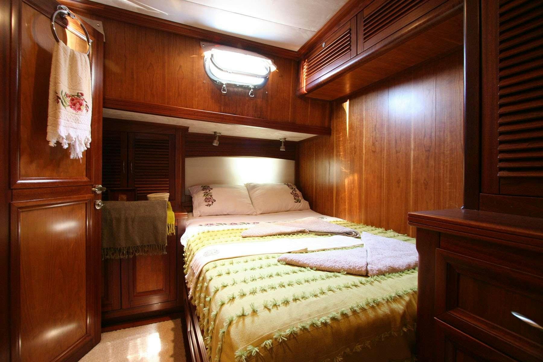 a room with a bed and a closet aboard LADY FREYA Yacht for Charter