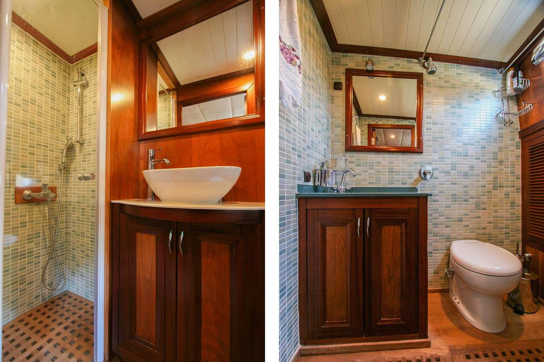 a bathroom with a sink toilet and a mirror aboard LADY FREYA Yacht for Charter