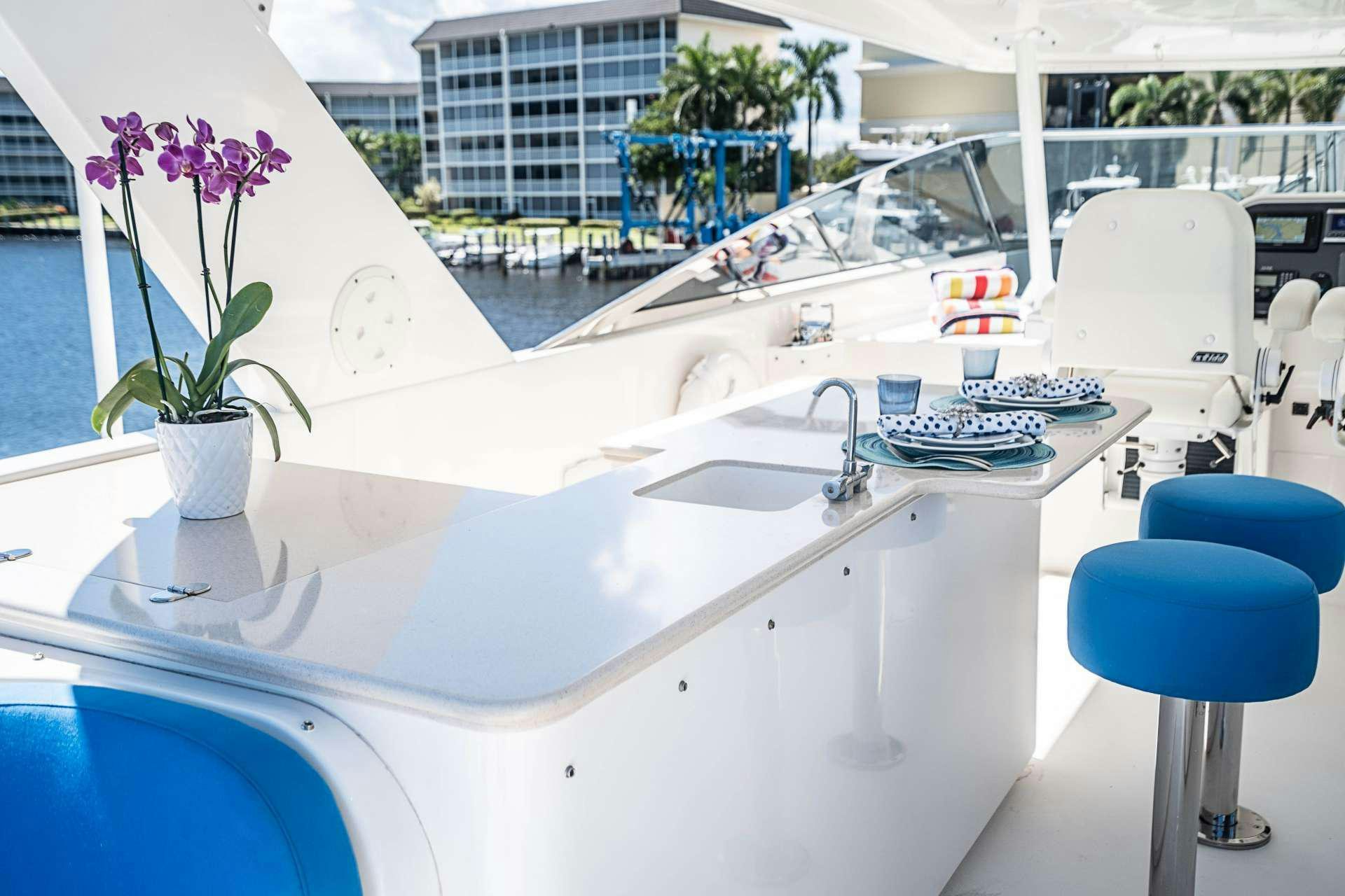 a white kitchen with a large window aboard TRUE NORTH Yacht for Charter