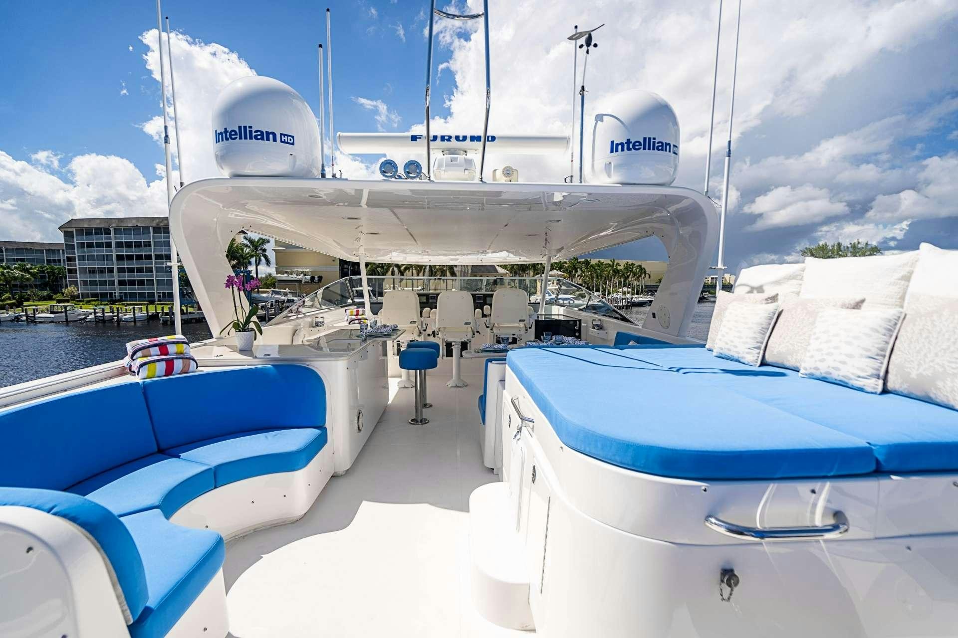 a white boat on a dock aboard TRUE NORTH Yacht for Charter
