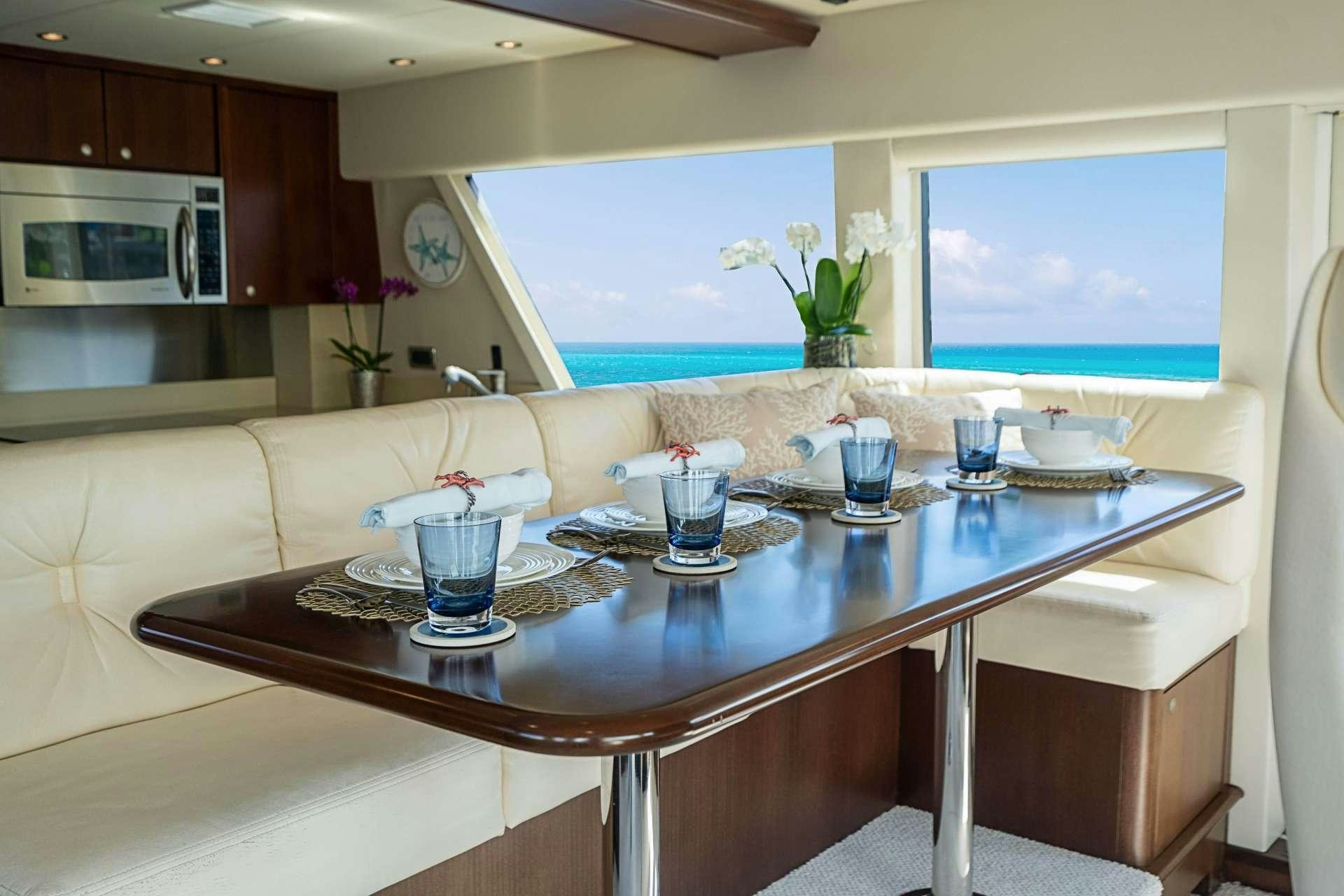 a kitchen with a table and chairs aboard TRUE NORTH Yacht for Charter