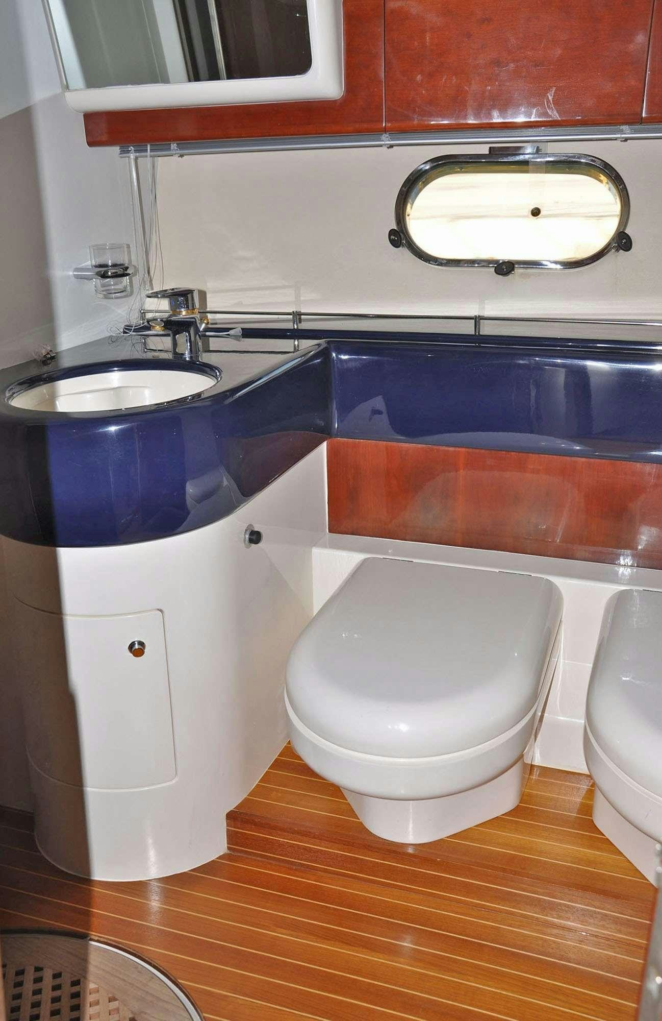 a bathroom with a tub sink and toilet aboard MARIA VEK Yacht for Charter