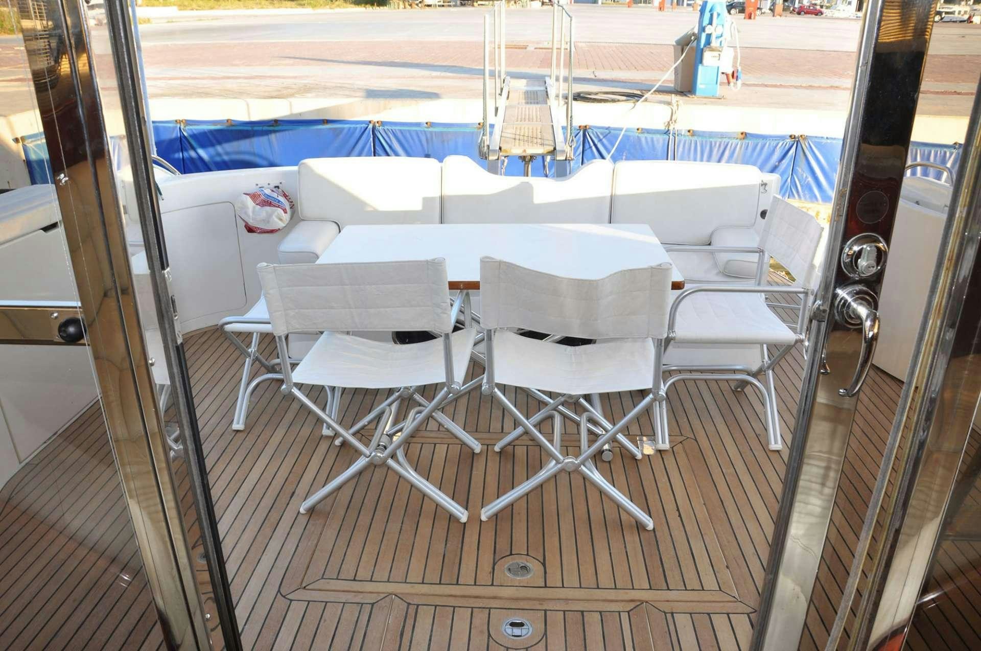 a table and chairs on a deck aboard MARIA VEK Yacht for Charter