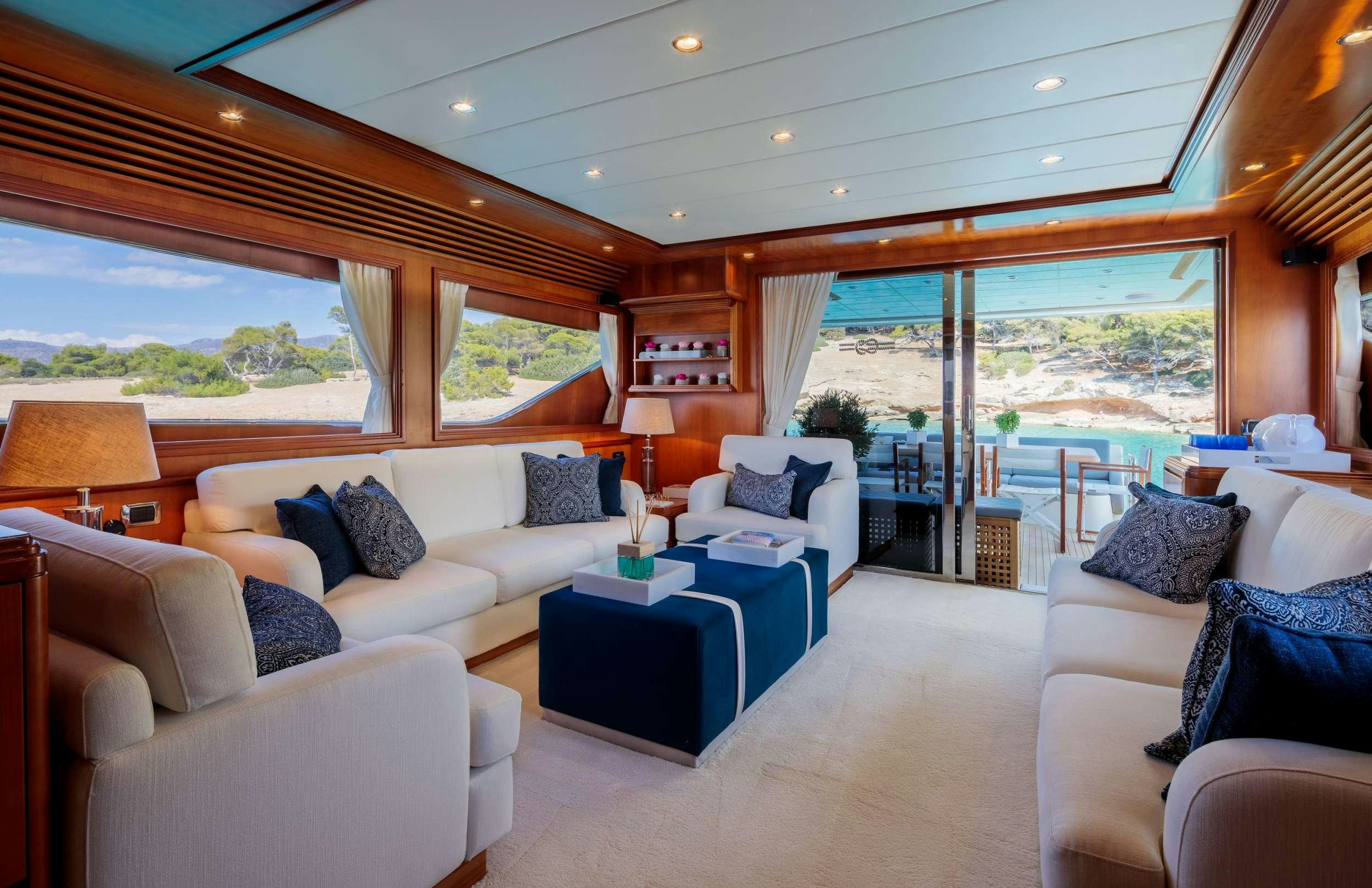 a living room with a large window aboard FREEDOM Yacht for Charter