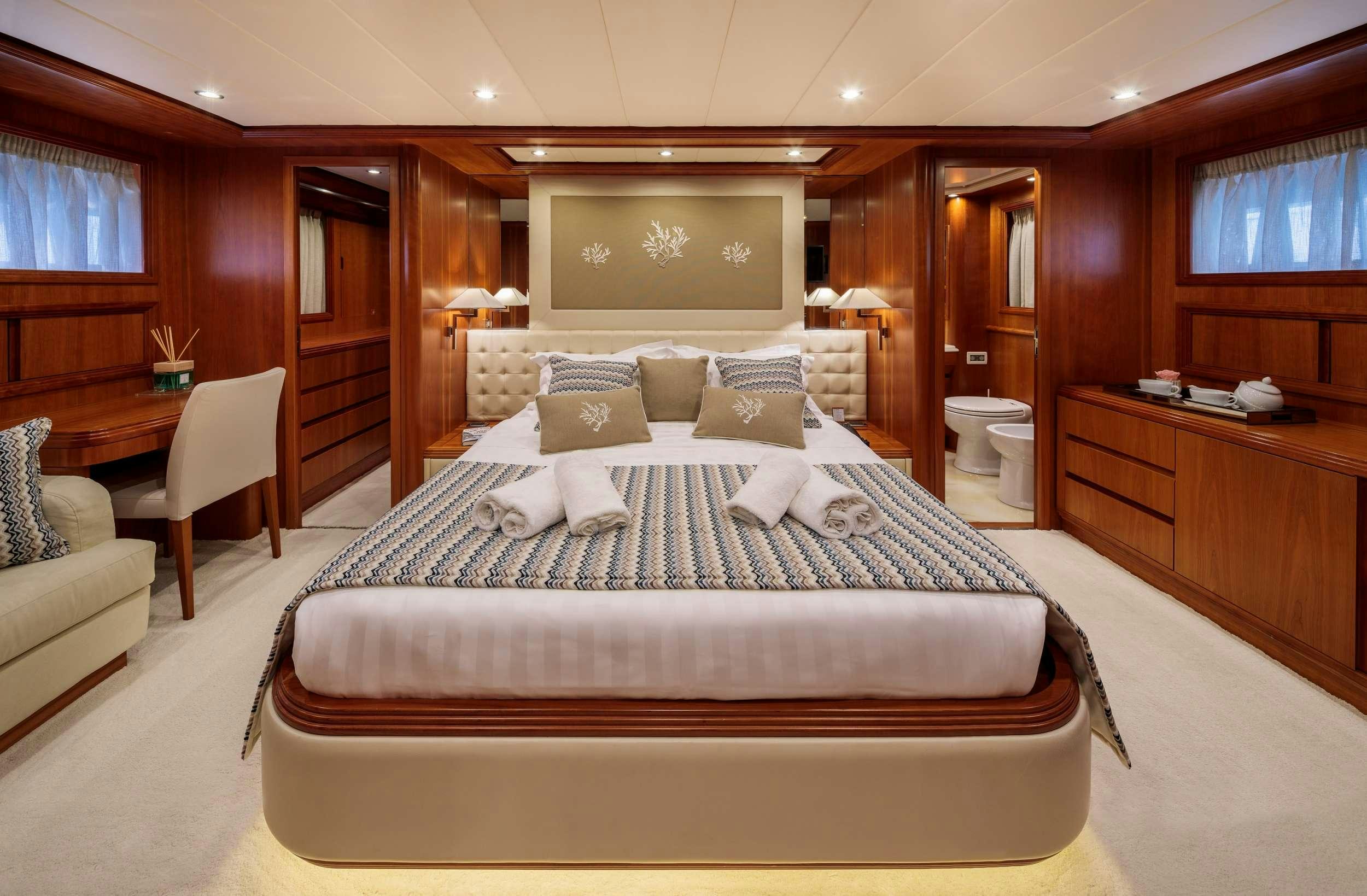 a large bed in a room aboard FREEDOM Yacht for Charter