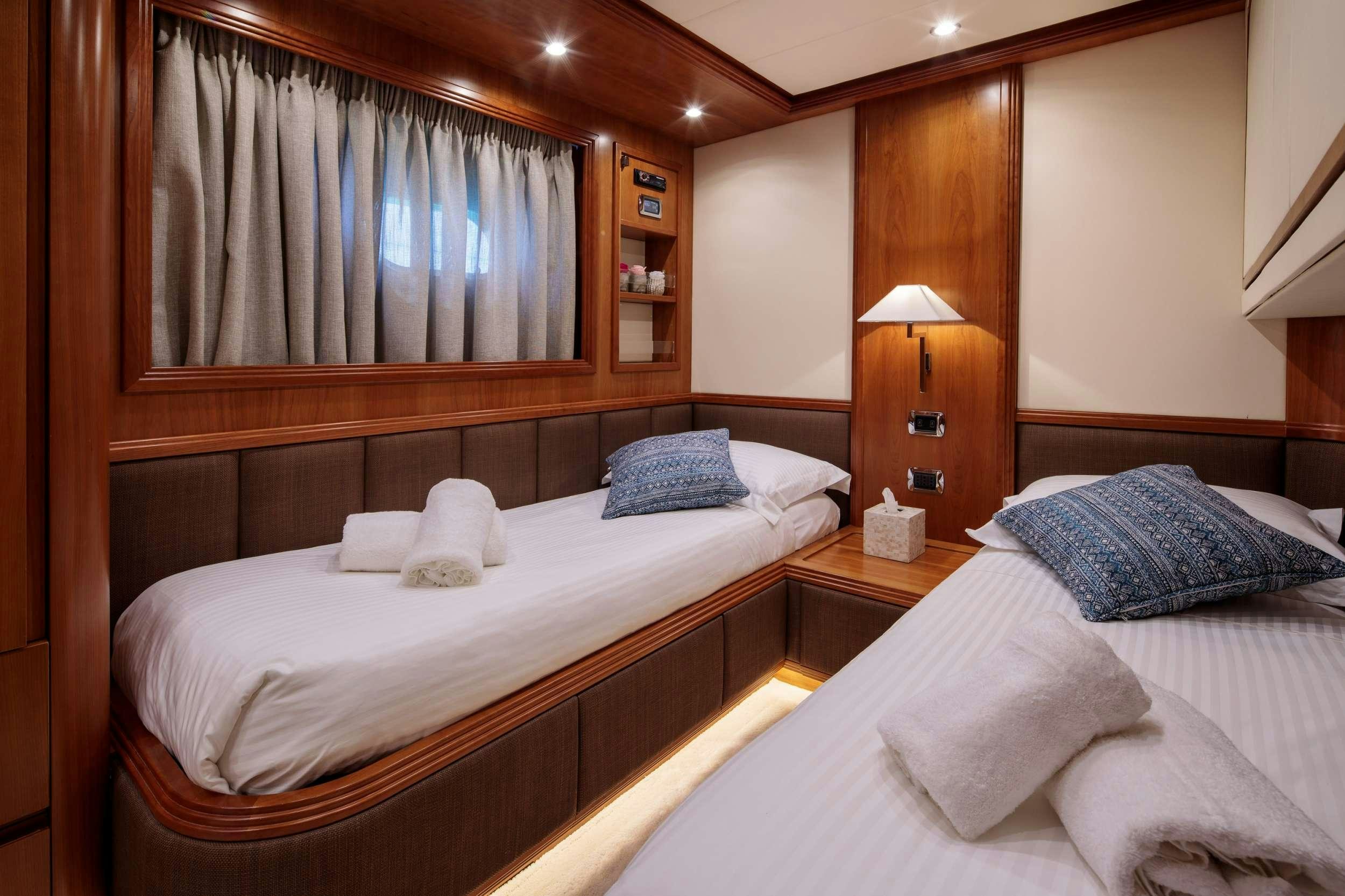 a couple of beds in a room aboard FREEDOM Yacht for Charter