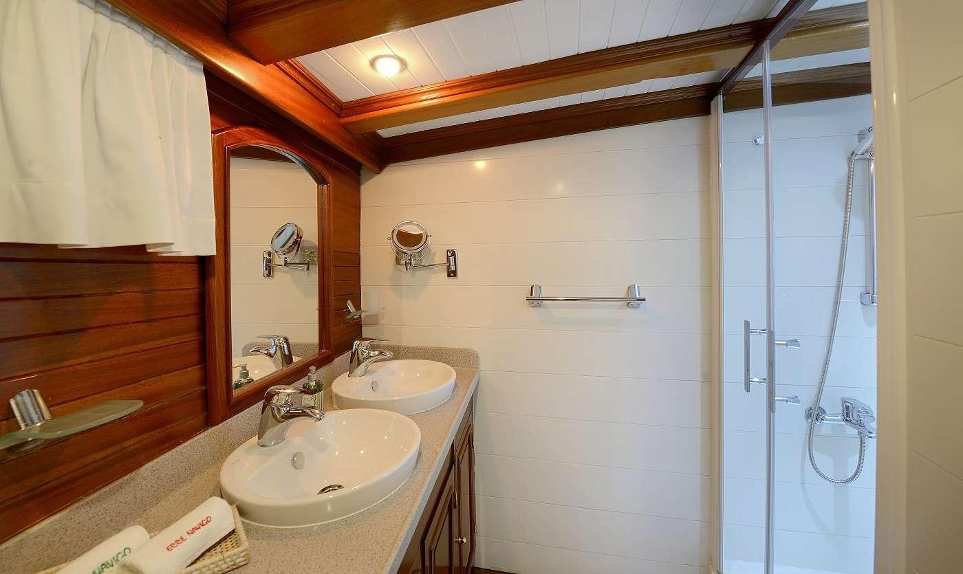 a bathroom with two sinks and a shower unit aboard ECCE NAVIGO Yacht for Charter