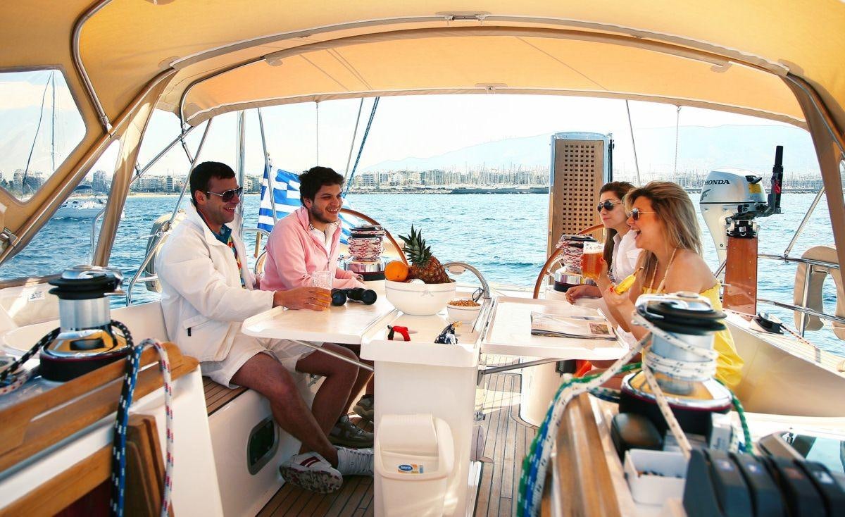 a group of people sitting on a boat aboard MYTHOS Yacht for Charter