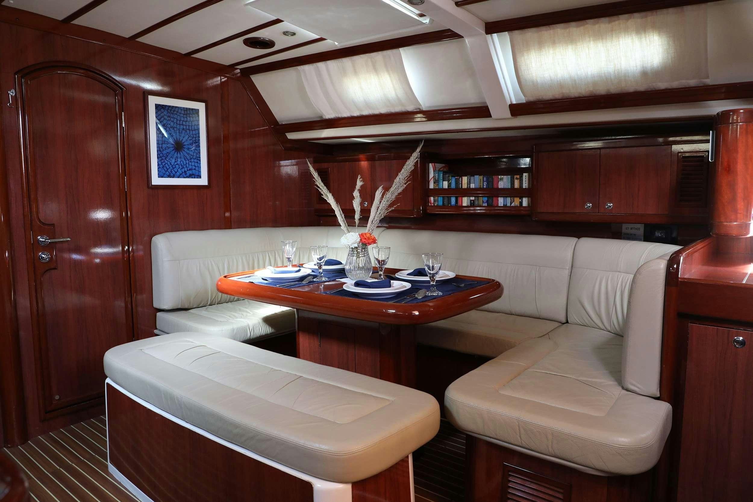 a room with a table and couches aboard MYTHOS Yacht for Charter