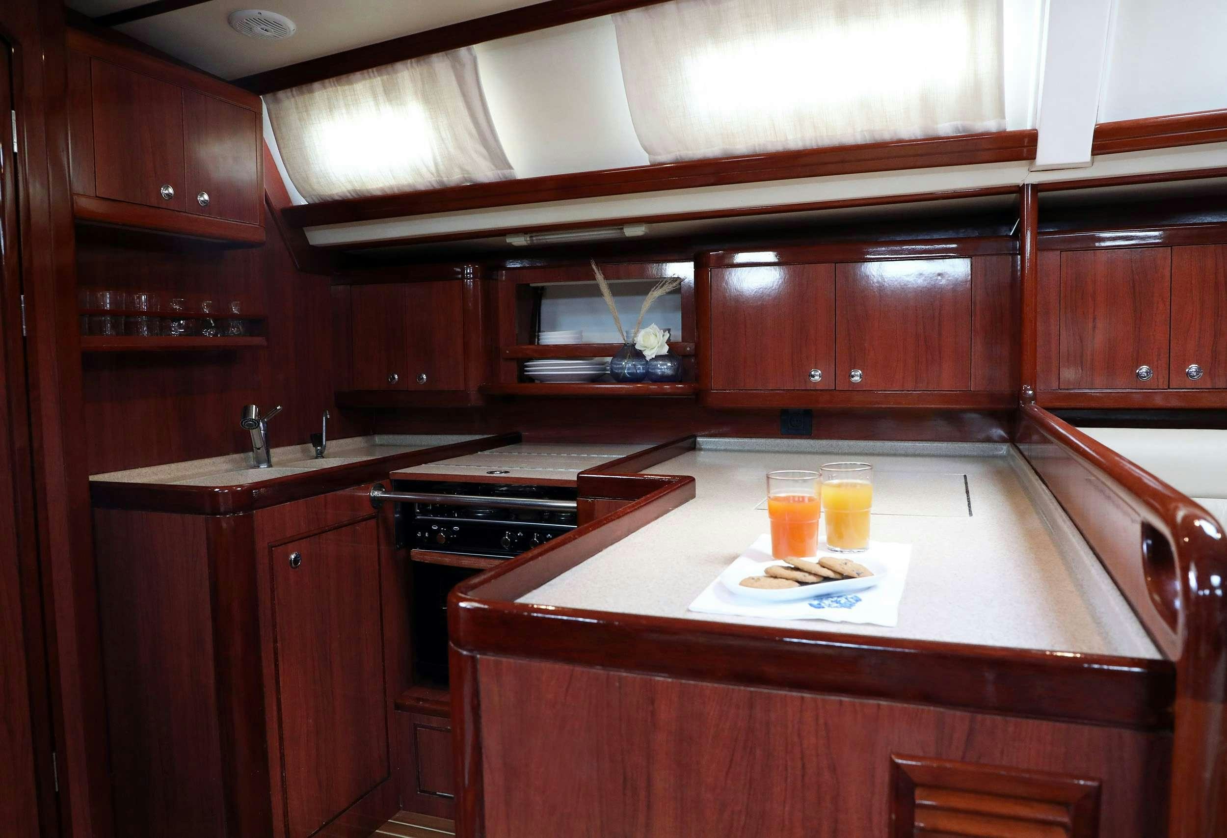 a kitchen with wooden cabinets aboard MYTHOS Yacht for Charter