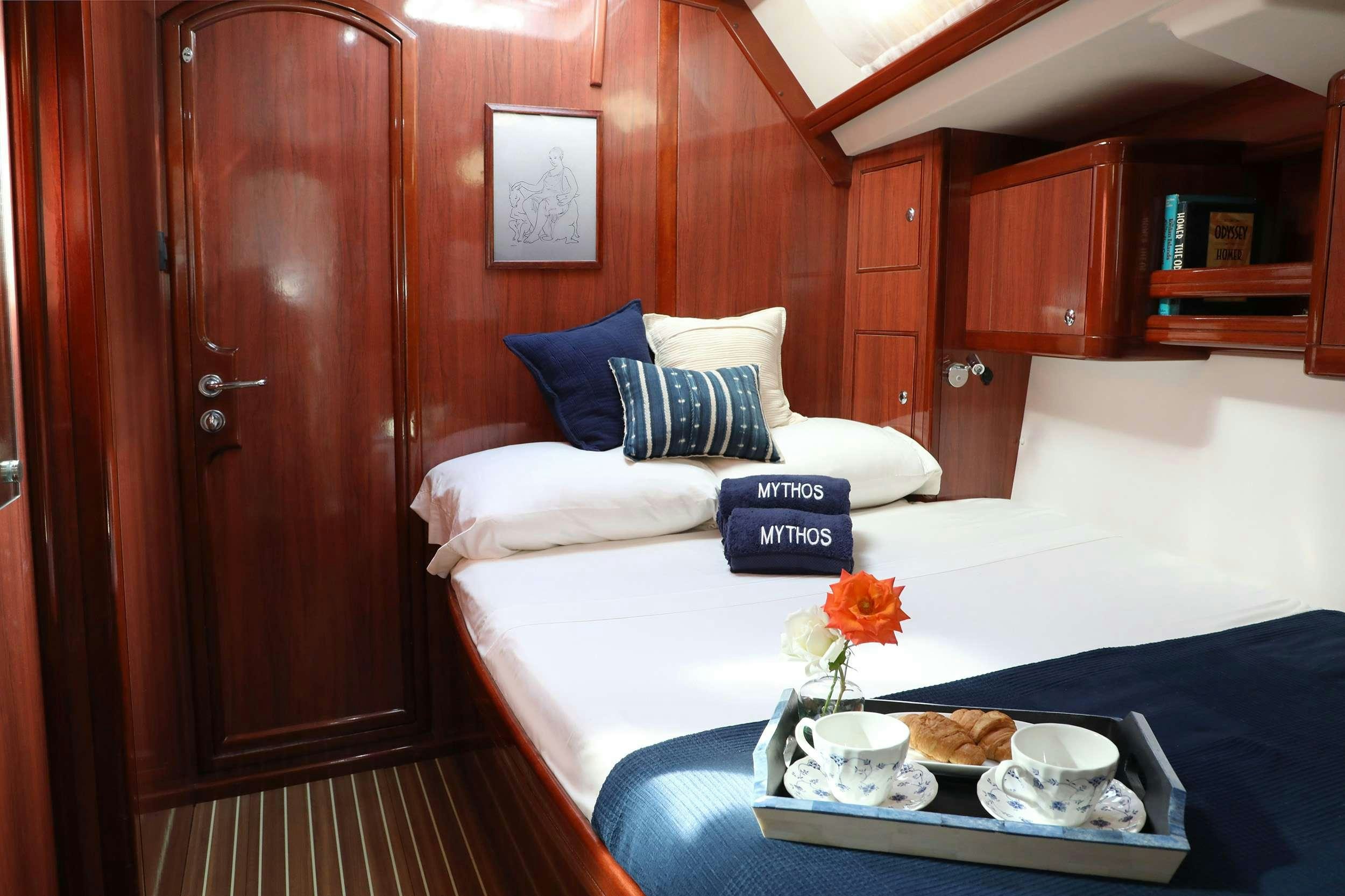 a bed with a tray of food aboard MYTHOS Yacht for Charter