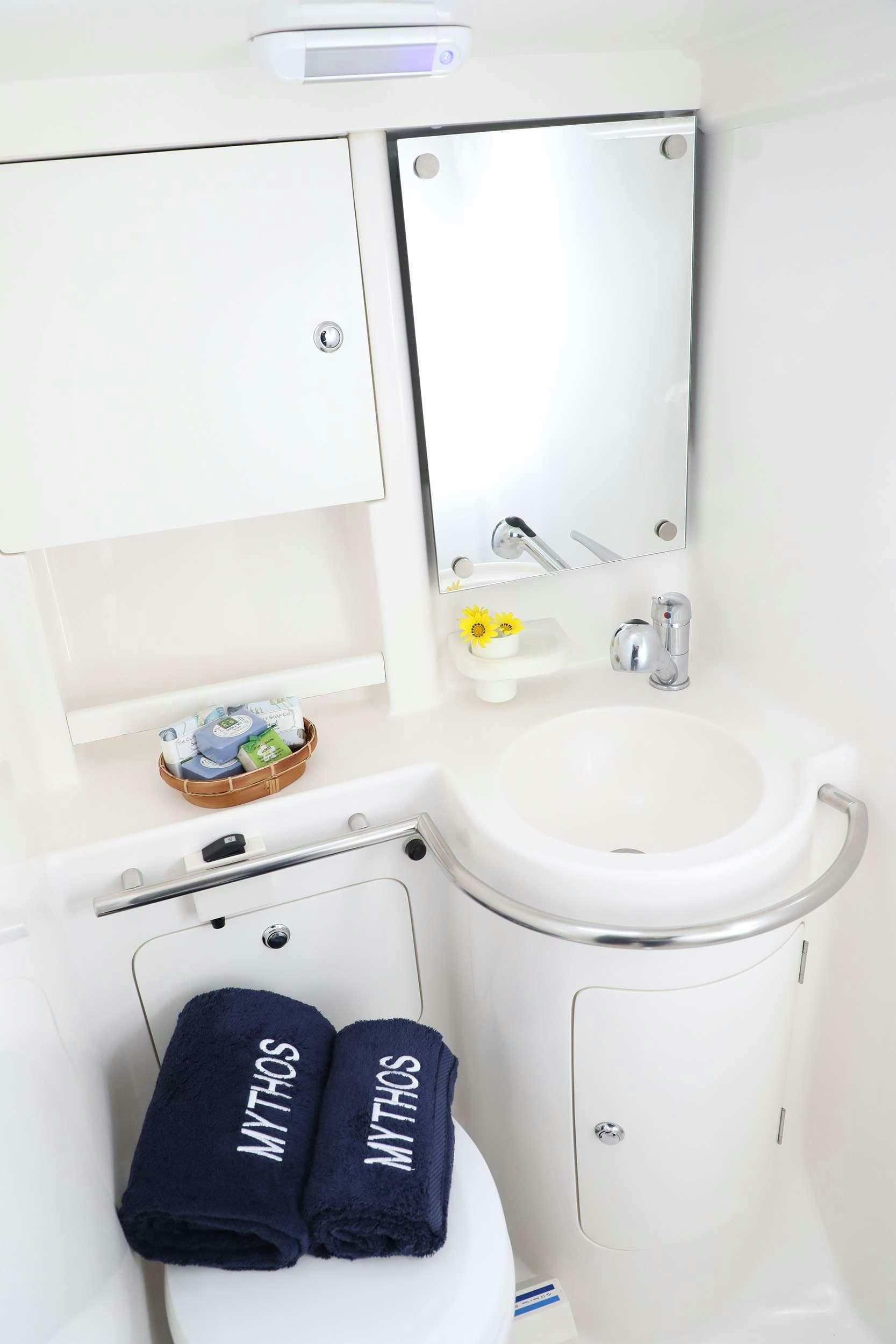 a bathroom with a sink and mirror aboard MYTHOS Yacht for Charter