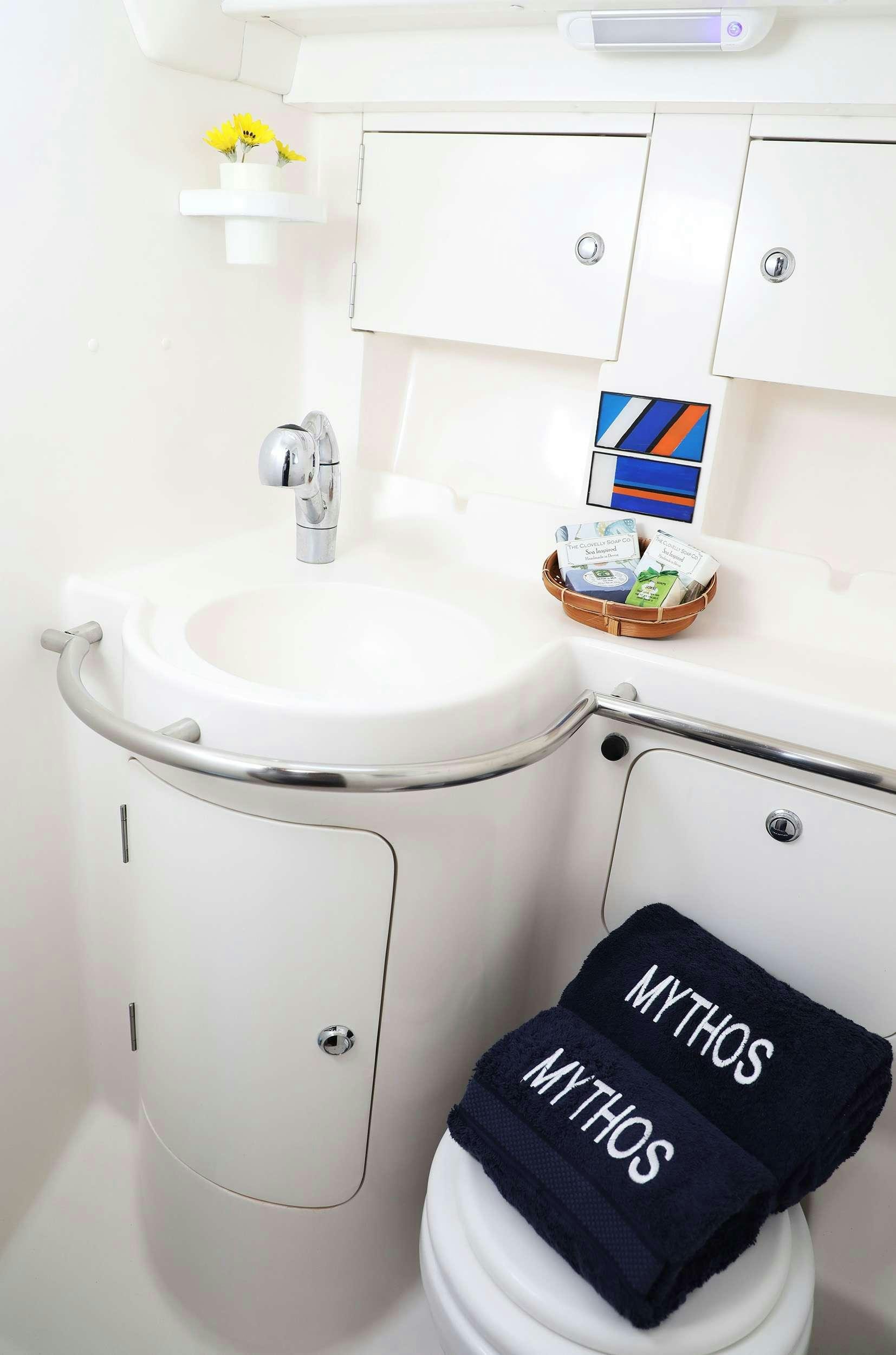 a white sink with a black hat on top aboard MYTHOS Yacht for Charter