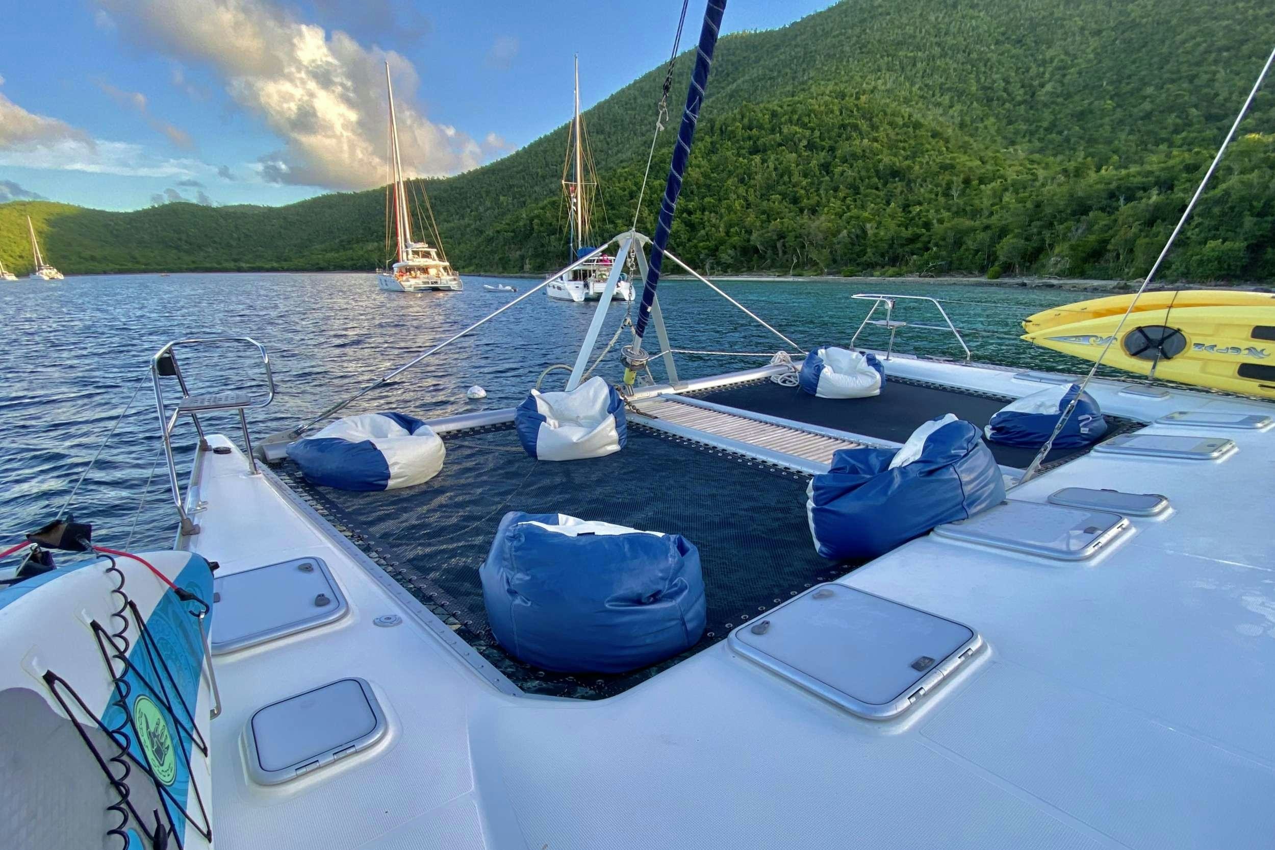 a boat with blue and white sail aboard YES DEAR Yacht for Charter