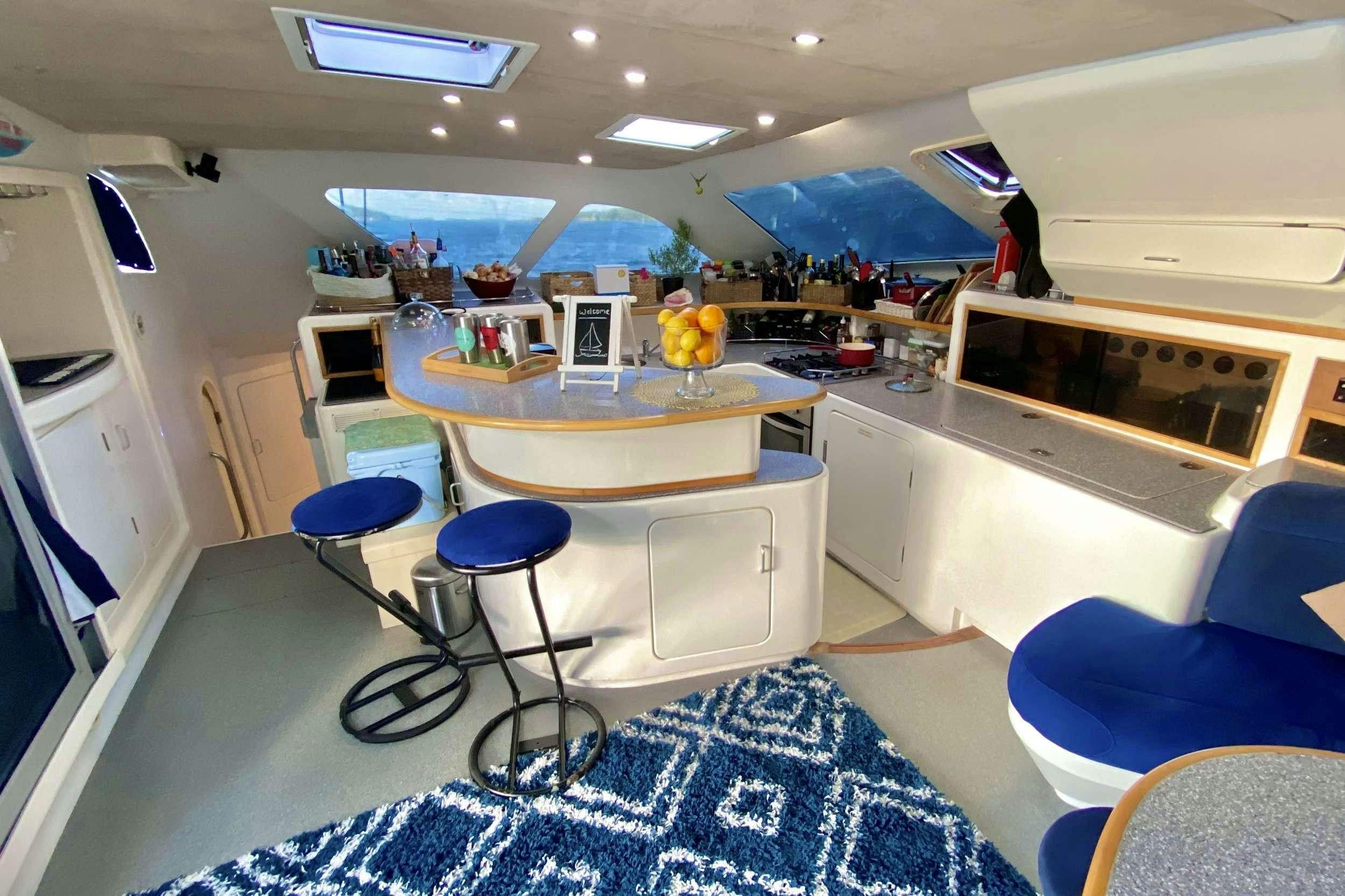 a room with a table and chairs aboard YES DEAR Yacht for Charter