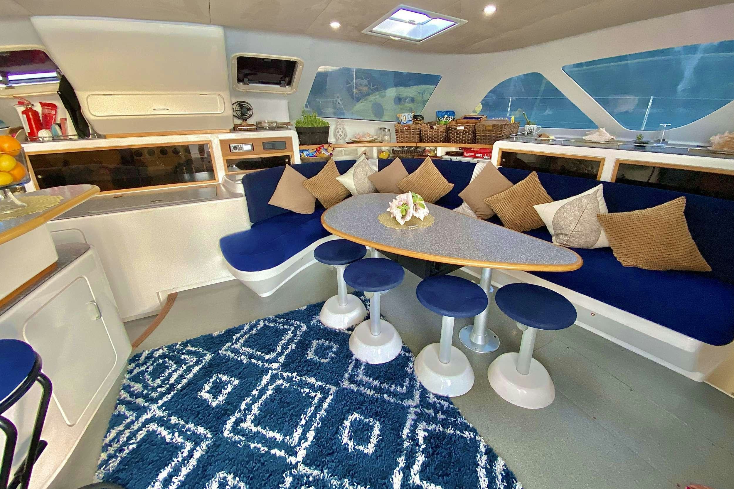 a room with a couch and a table aboard YES DEAR Yacht for Charter
