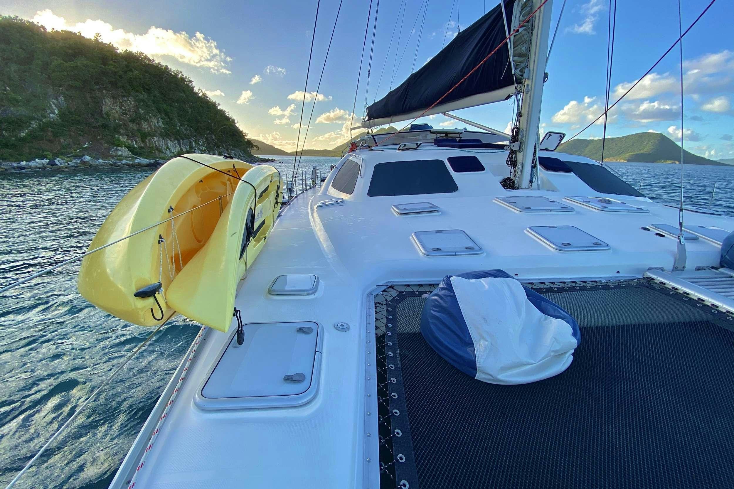a boat with a yellow and white canopy on the front aboard YES DEAR Yacht for Charter