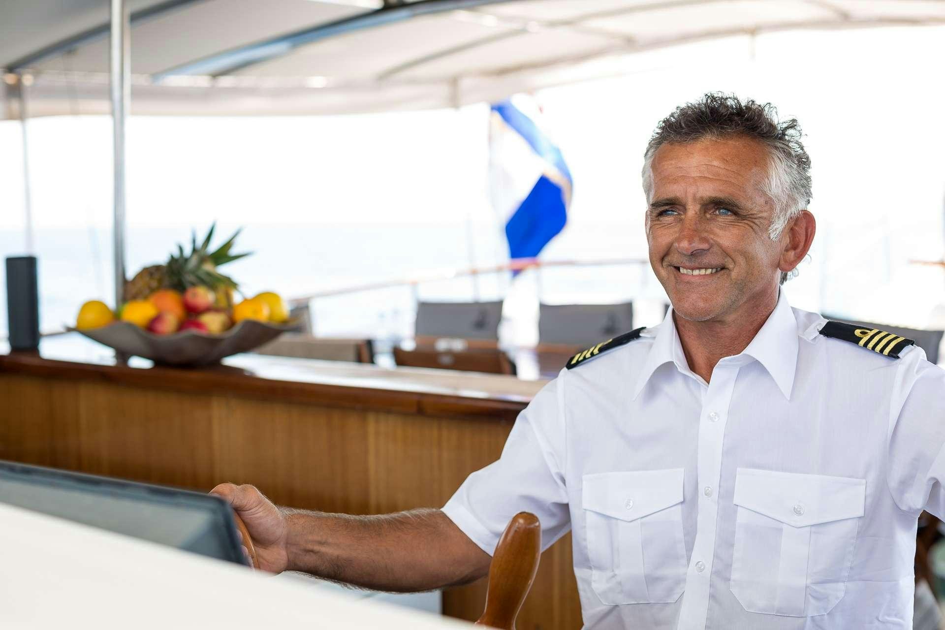 a man in a white shirt aboard ALLUREE Yacht for Charter