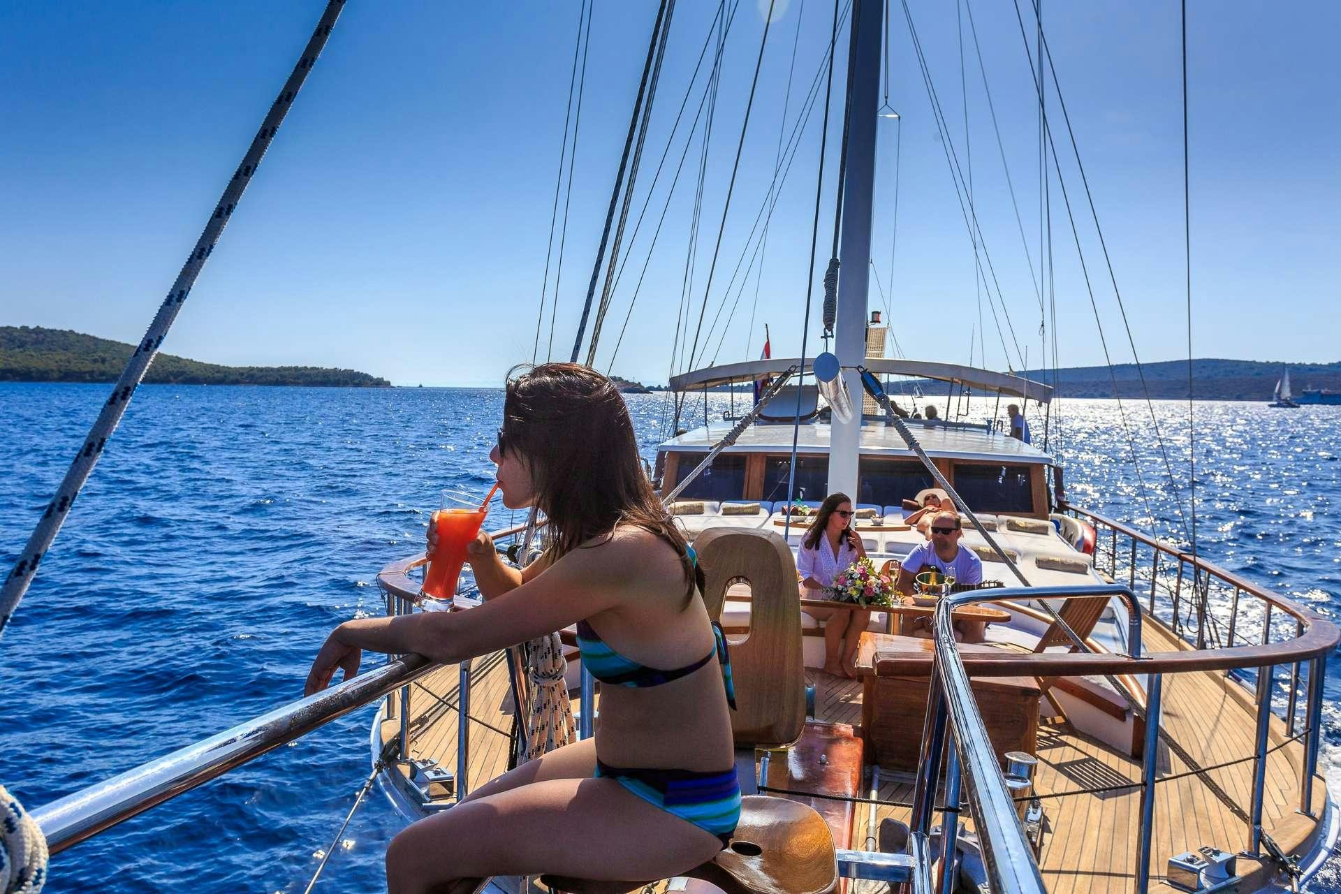a woman in a bikini on a boat aboard ALLUREE Yacht for Charter