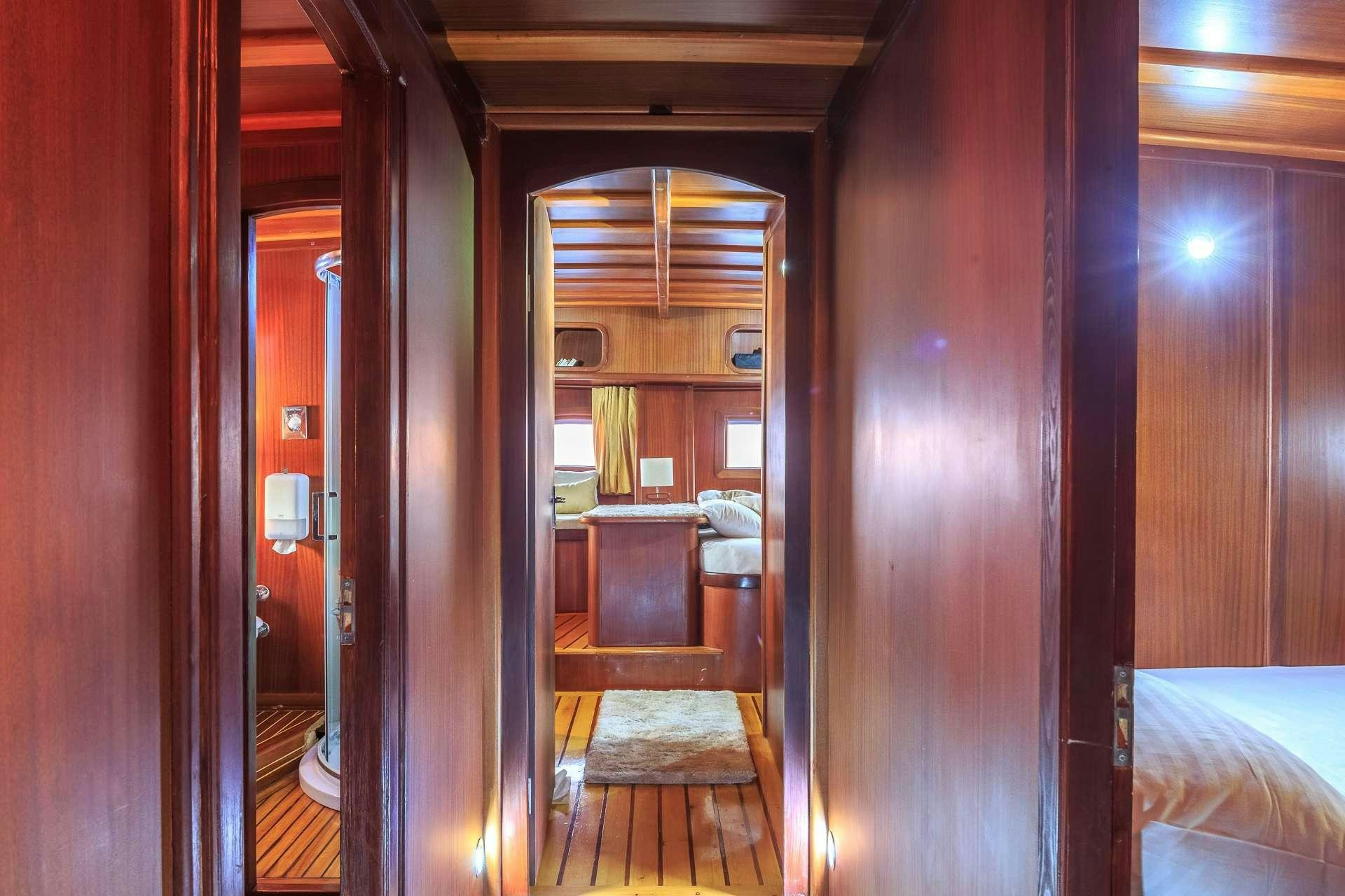 a room with a bed and a mirror aboard ALLUREE Yacht for Charter