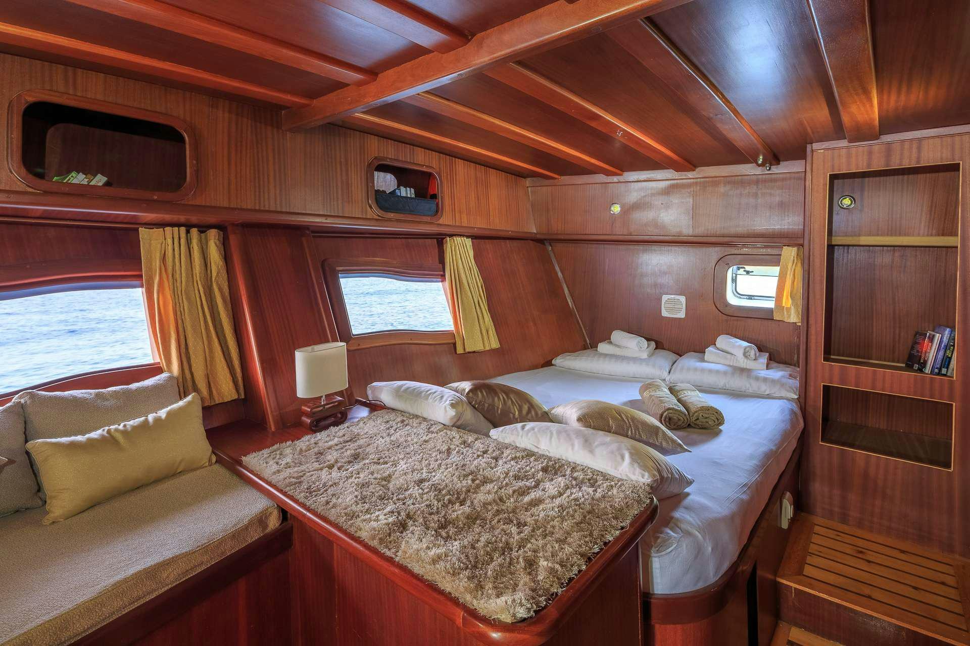 a cabin with a bed aboard ALLUREE Yacht for Charter