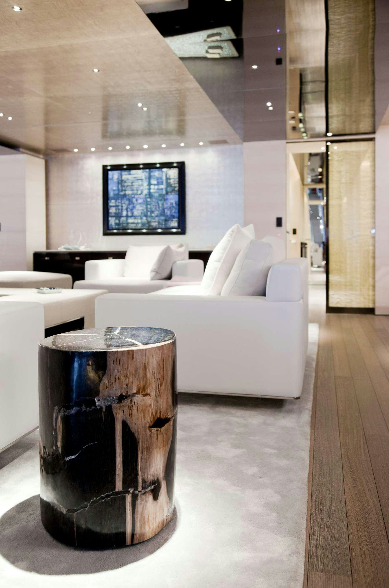 a black coffee cup on a glass table in a room with a couch and a television aboard ASLEC 4 Yacht for Charter