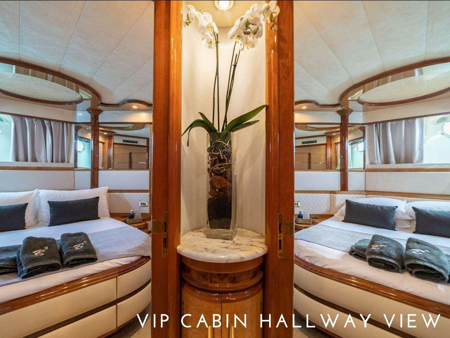 a room with a plant in a vase and a bed aboard B3 Yacht for Charter