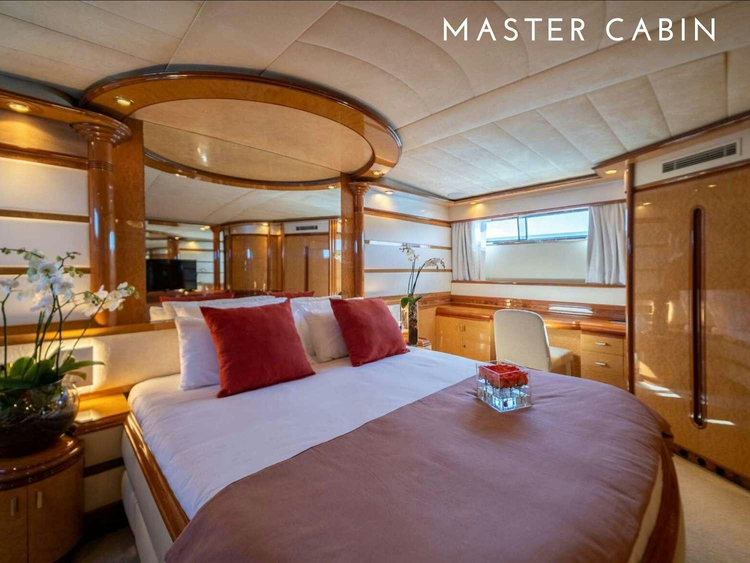 a bed with a pink pillow aboard B3 Yacht for Charter