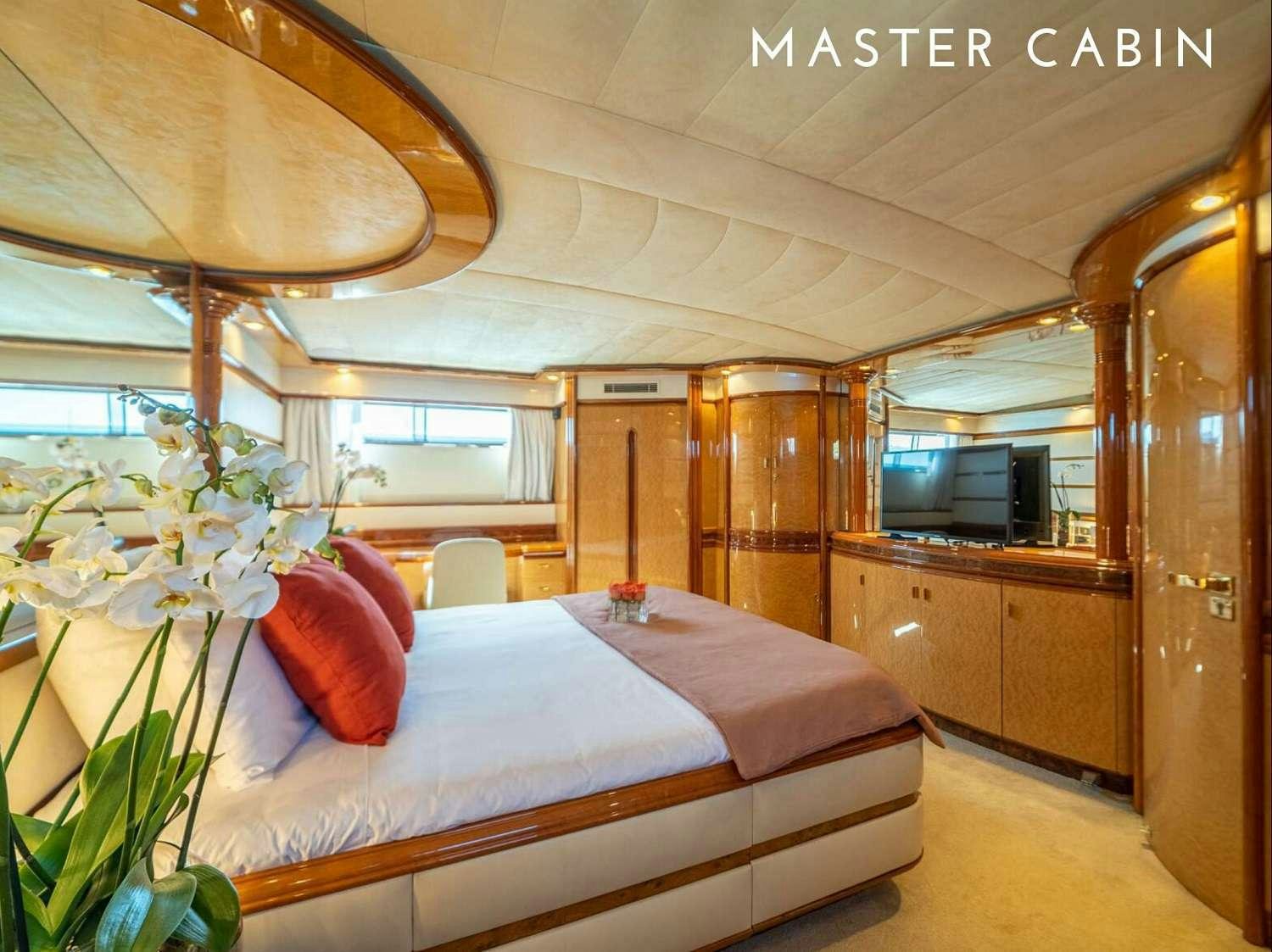 a bedroom with a bed and a wood cabinet aboard B3 Yacht for Charter