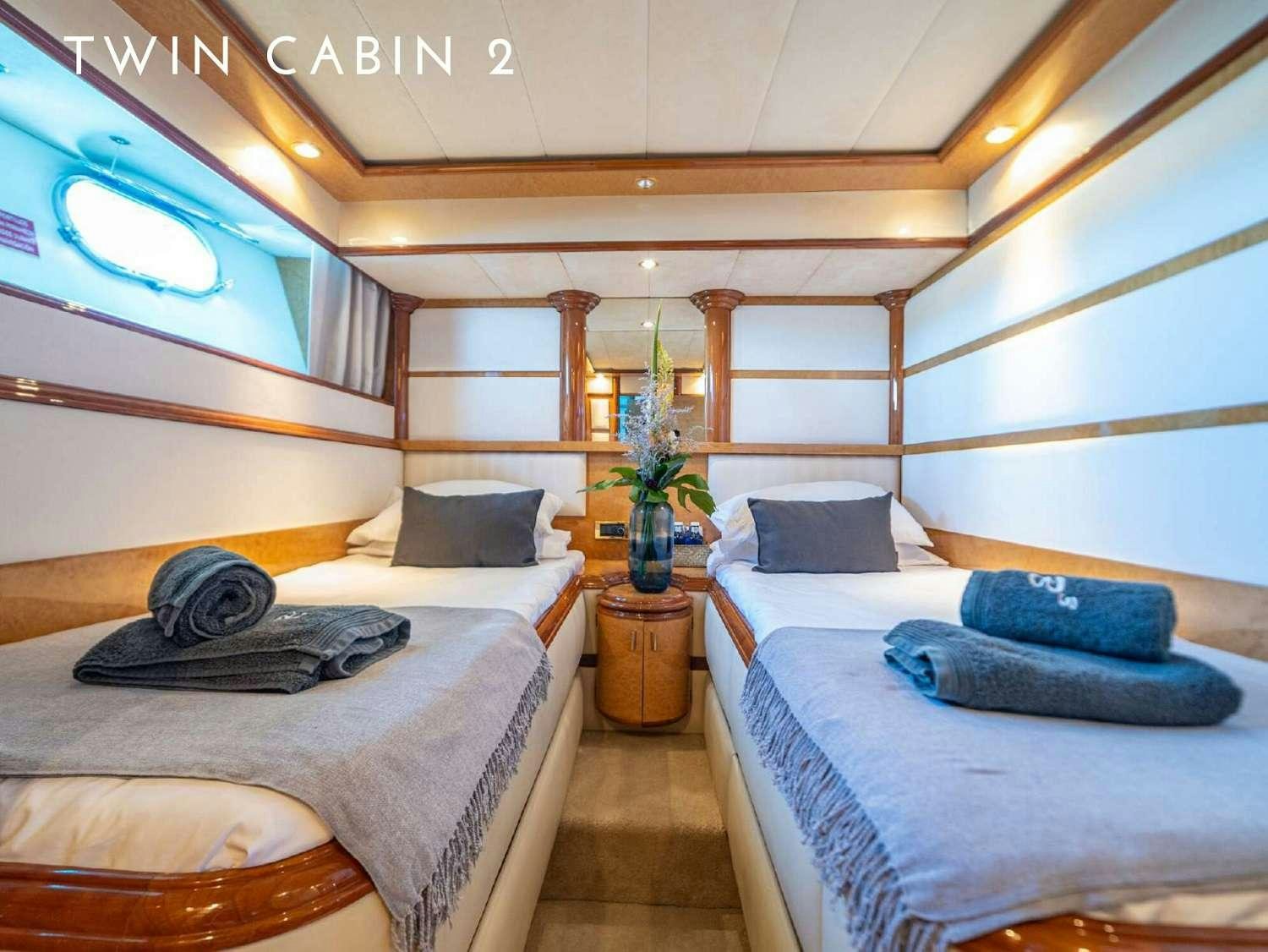 a room with a bed and a table aboard B3 Yacht for Charter