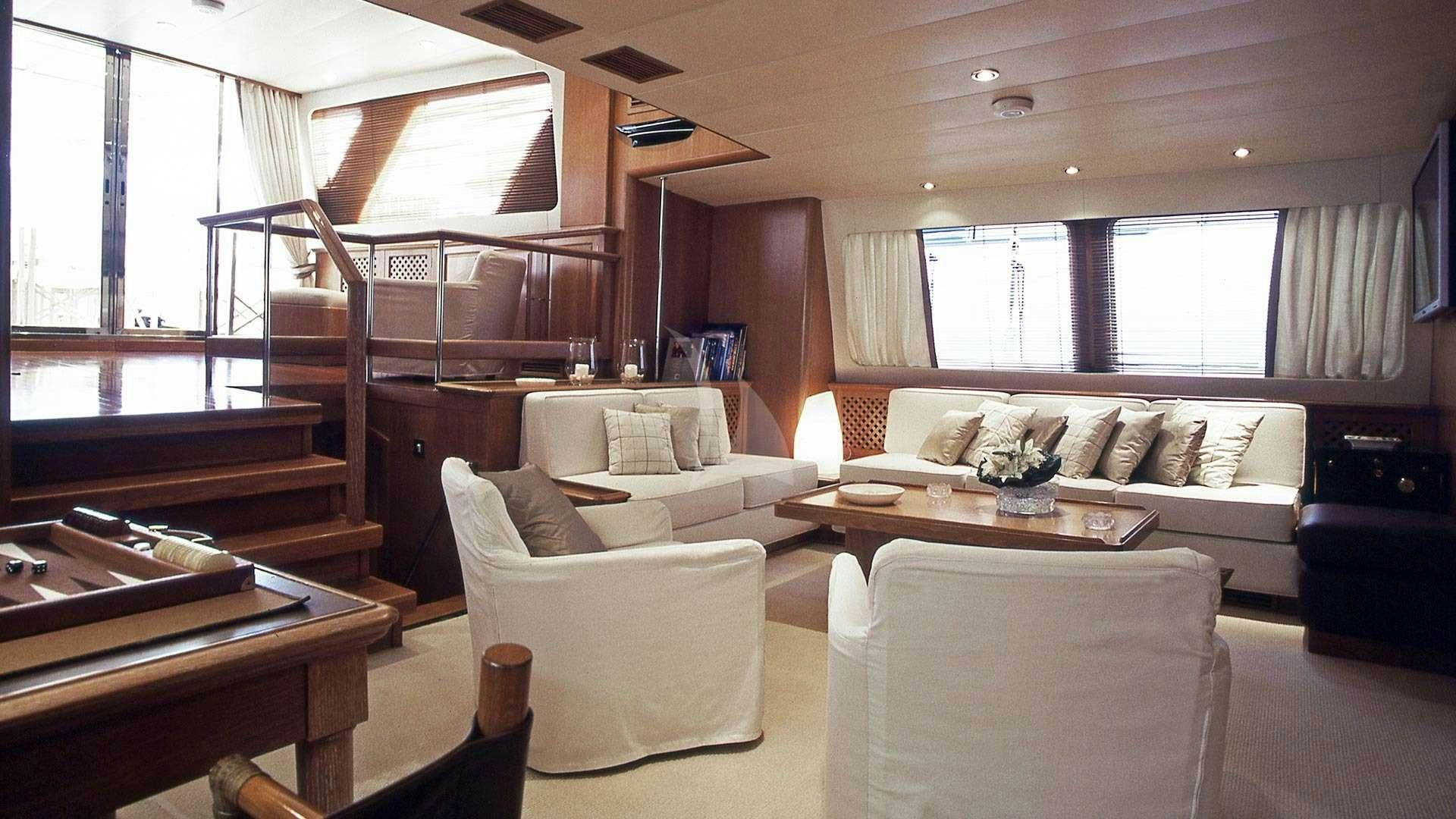 a living room with a couch and a table aboard ALTHEA Yacht for Charter