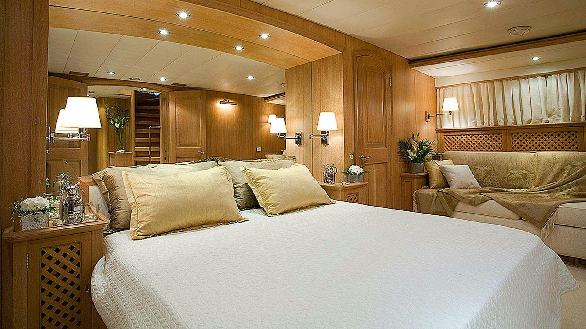 a large bed in a hotel room aboard ALTHEA Yacht for Charter