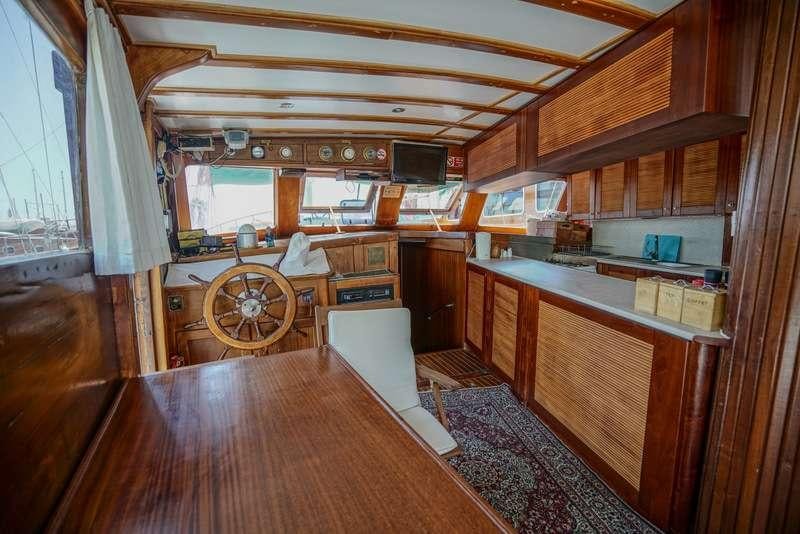 a kitchen with wooden cabinets aboard GOLDEN PRINCESS Yacht for Charter