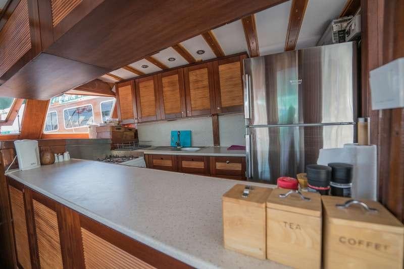 a kitchen with wooden cabinets aboard GOLDEN PRINCESS Yacht for Charter