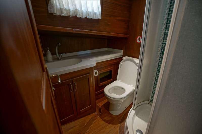 a bathroom with a toilet and sink aboard GOLDEN PRINCESS Yacht for Charter