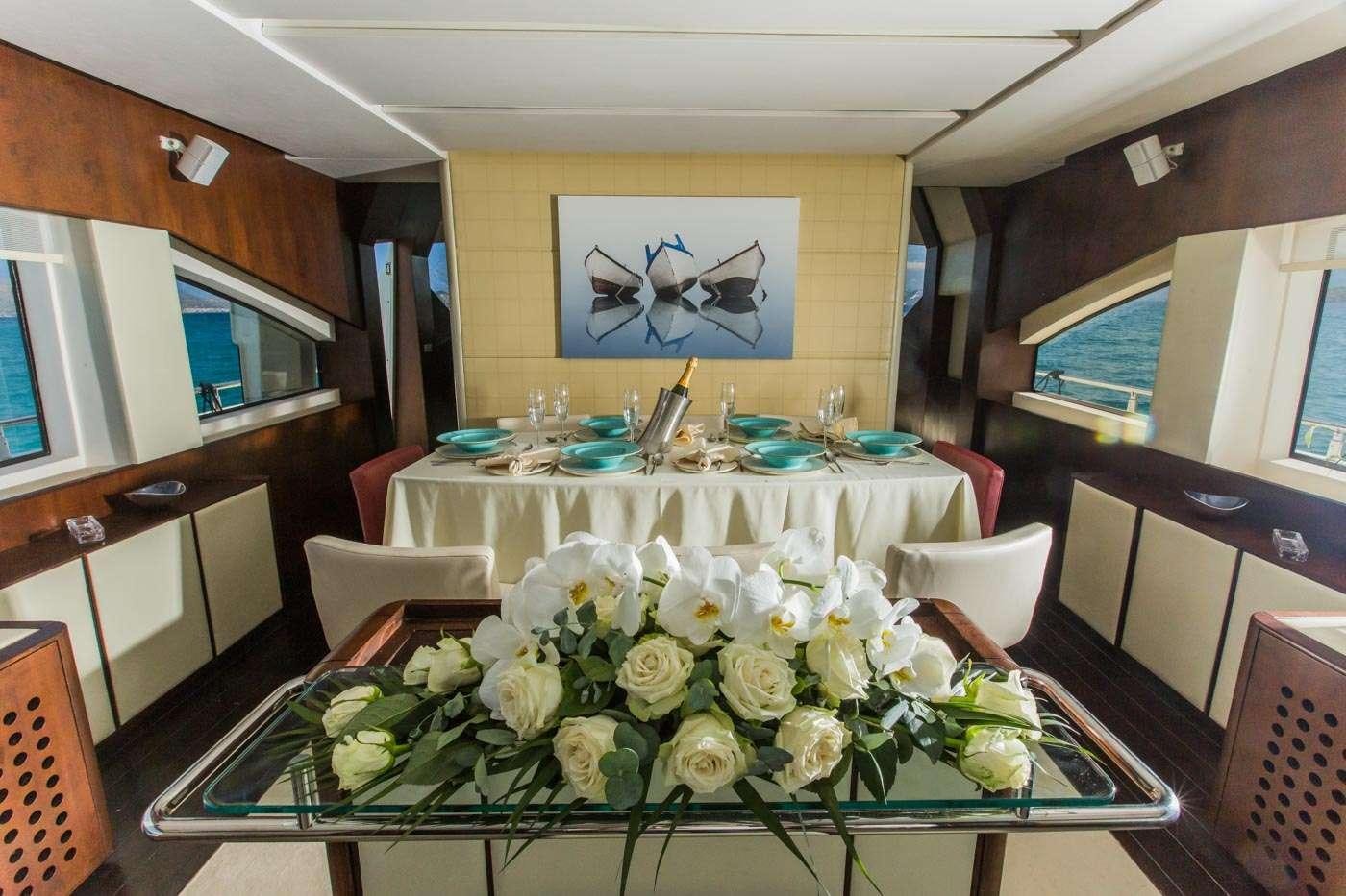a table with white flowers aboard ULISSE Yacht for Charter