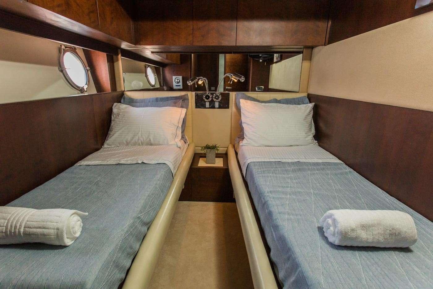a room with beds and a mirror aboard ULISSE Yacht for Charter