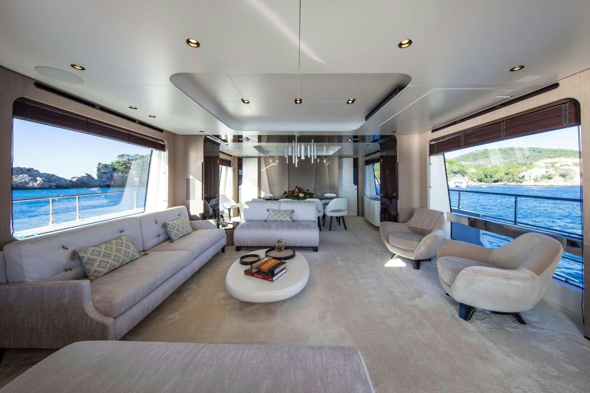 a living room with a large window aboard AKAMA Yacht for Charter