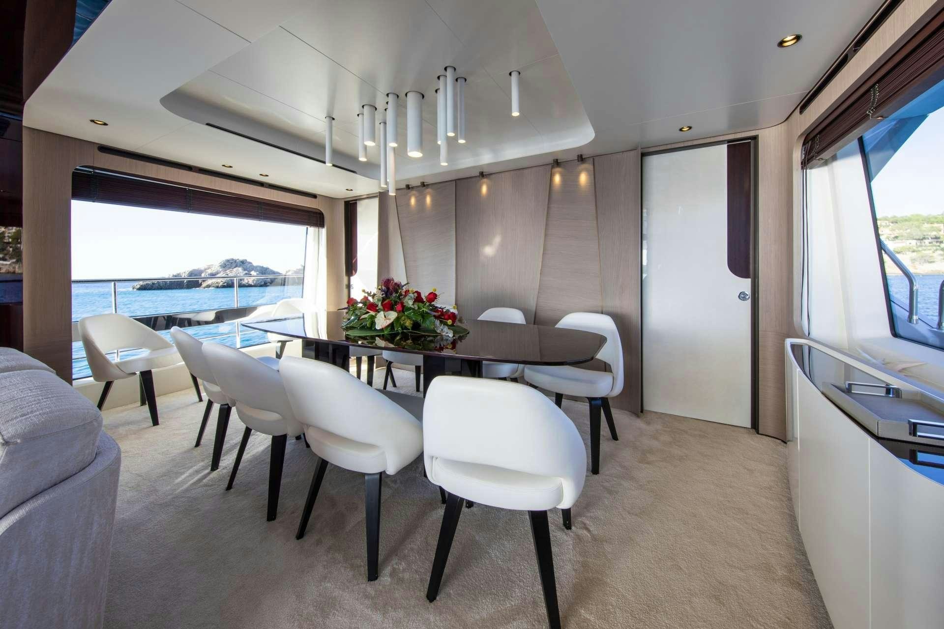 a room with a table and chairs aboard AKAMA Yacht for Charter