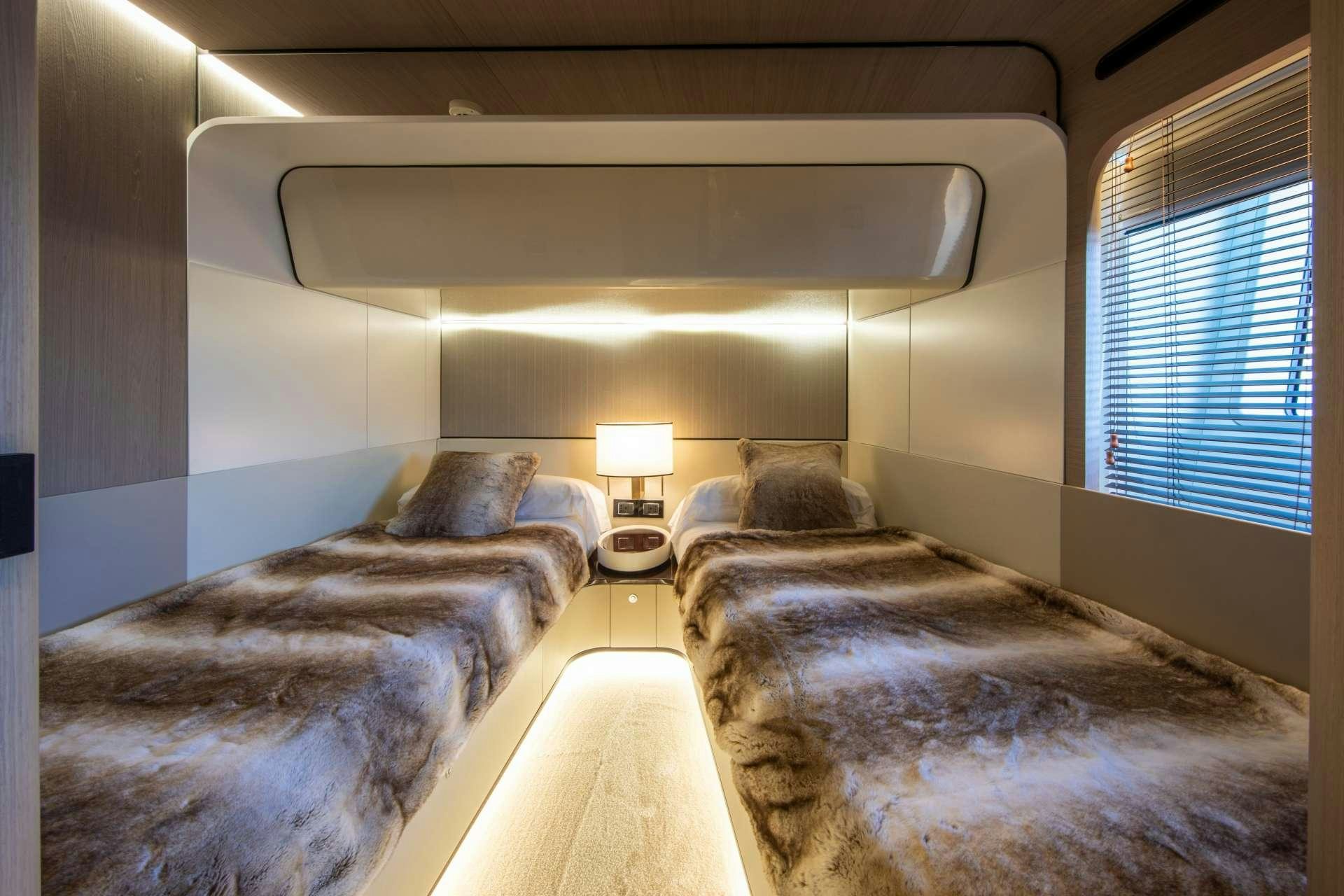 a room with two beds aboard AKAMA Yacht for Charter