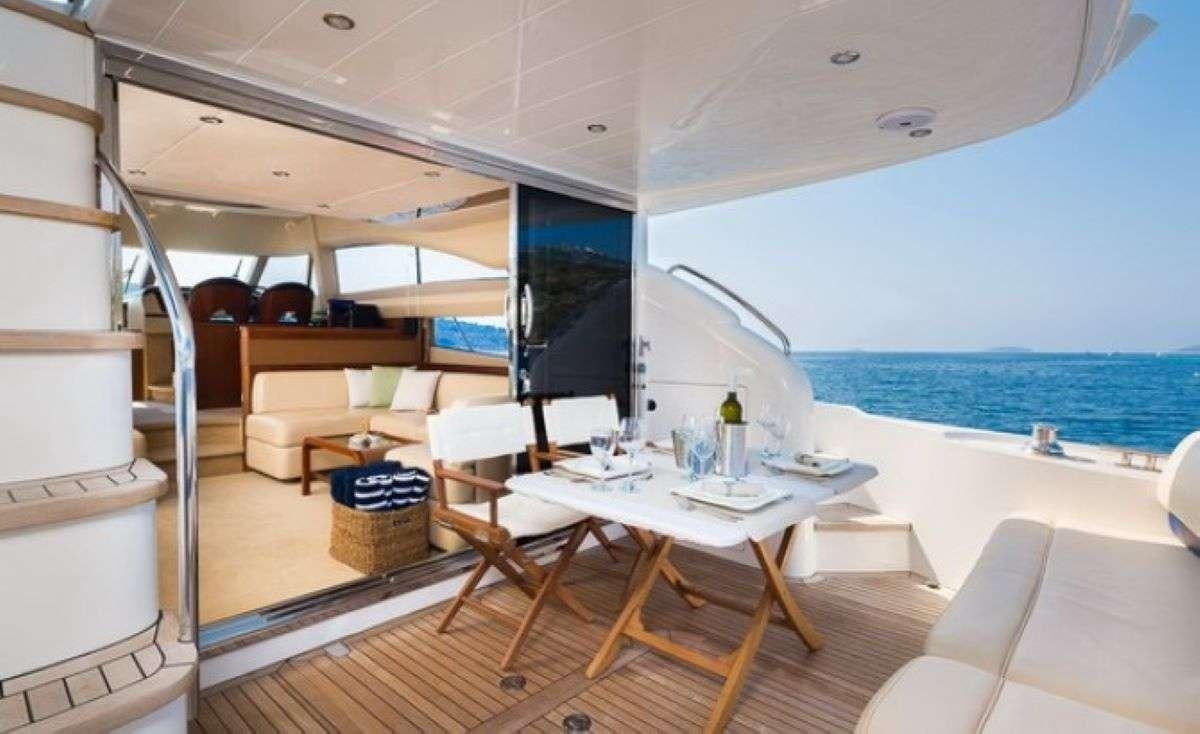 a room with a table and chairs aboard Anna Wo Yacht for Charter