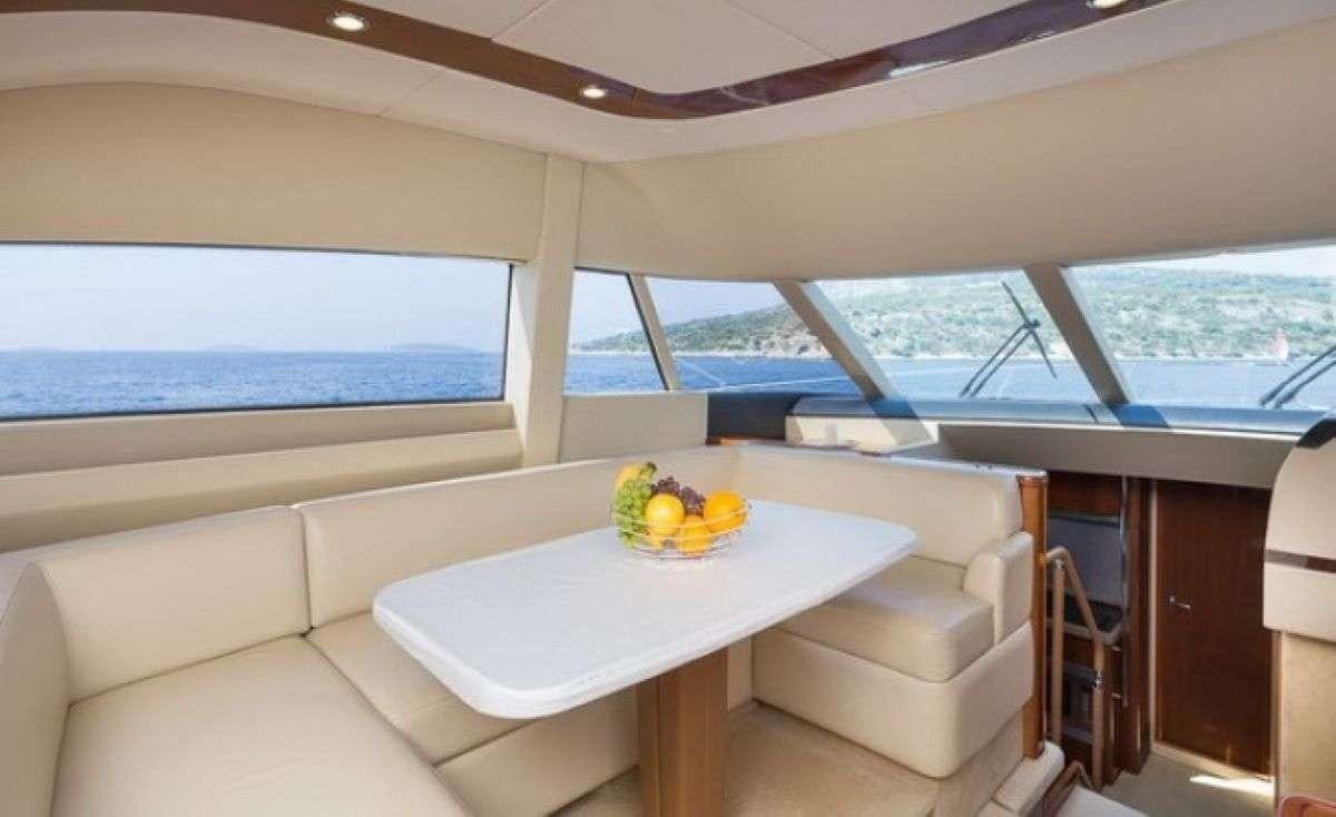 a room with a table and chairs aboard Anna Wo Yacht for Charter