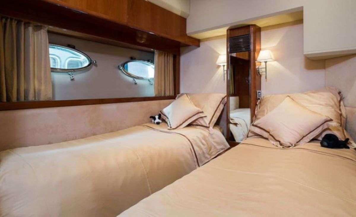 a hotel room with two beds aboard Anna Wo Yacht for Charter