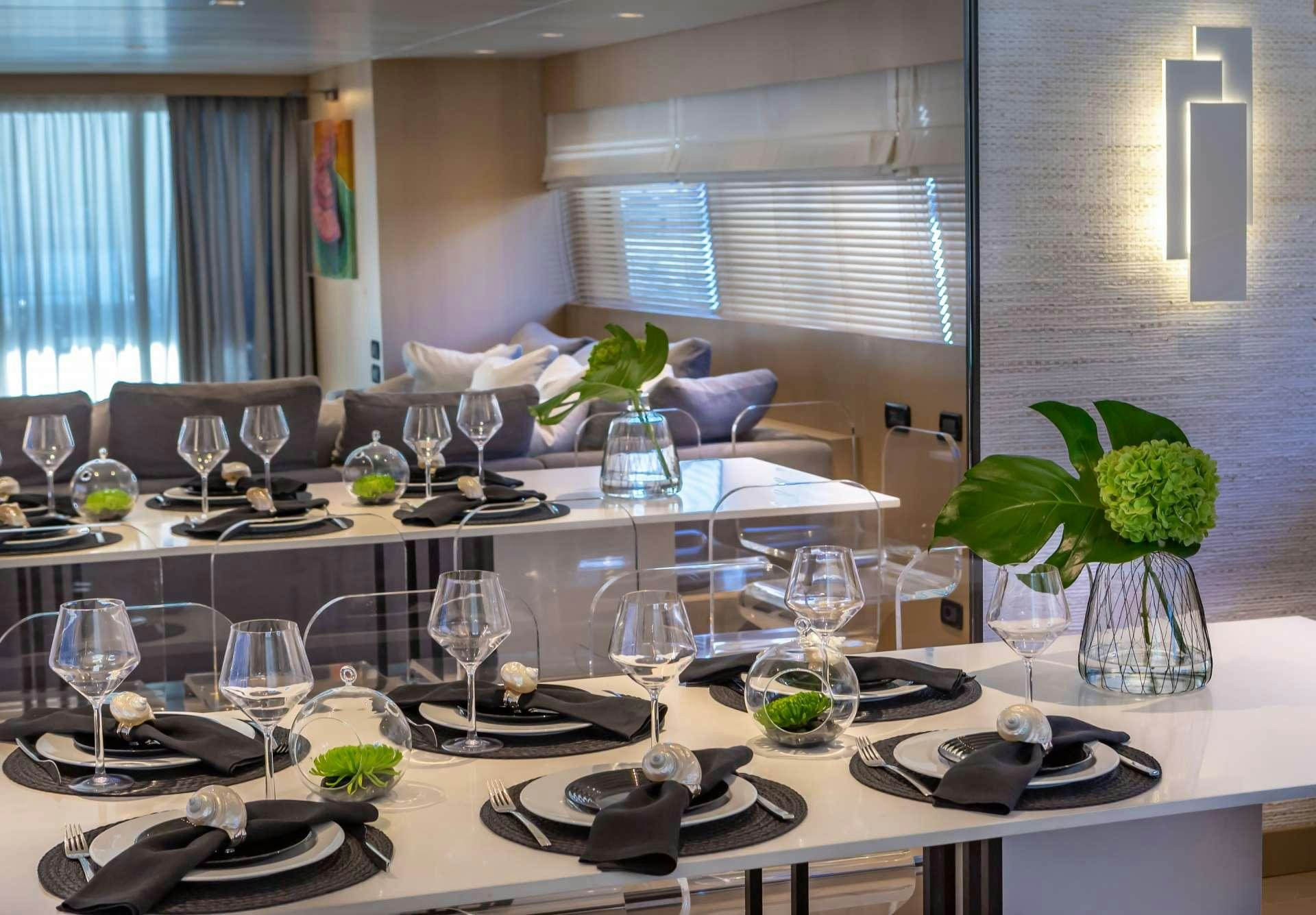 a large table with plates and glasses aboard SUMMER FUN Yacht for Charter
