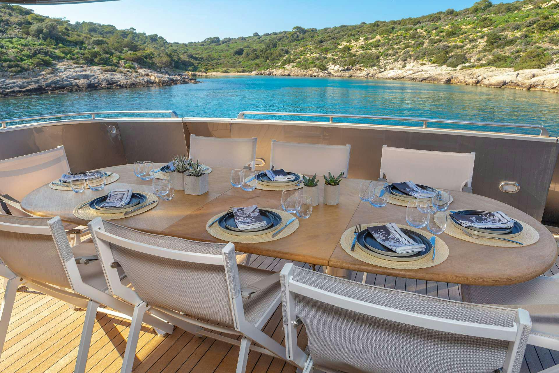 a table set for a meal on a beach aboard SUMMER FUN Yacht for Charter
