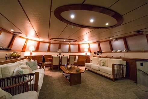 a room with a bed and a table aboard ATLANTIS II Yacht for Charter