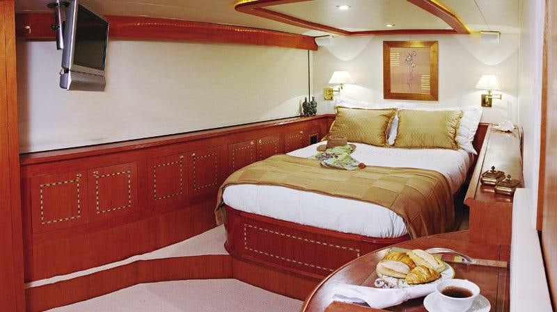 a hotel room with a bed and breakfast aboard ATLANTIS II Yacht for Charter